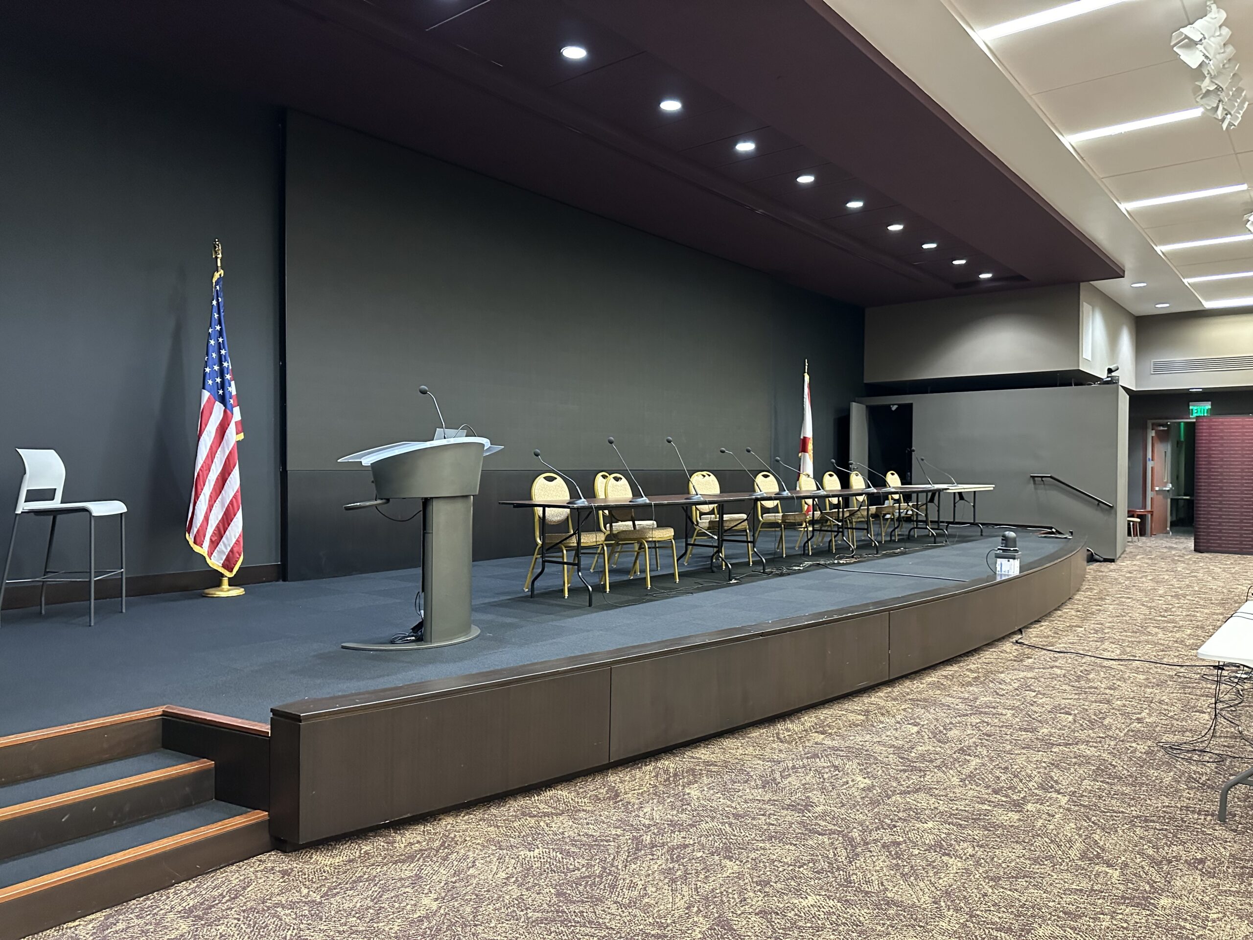 Raised stage, podium, and panel seating in Room 208
