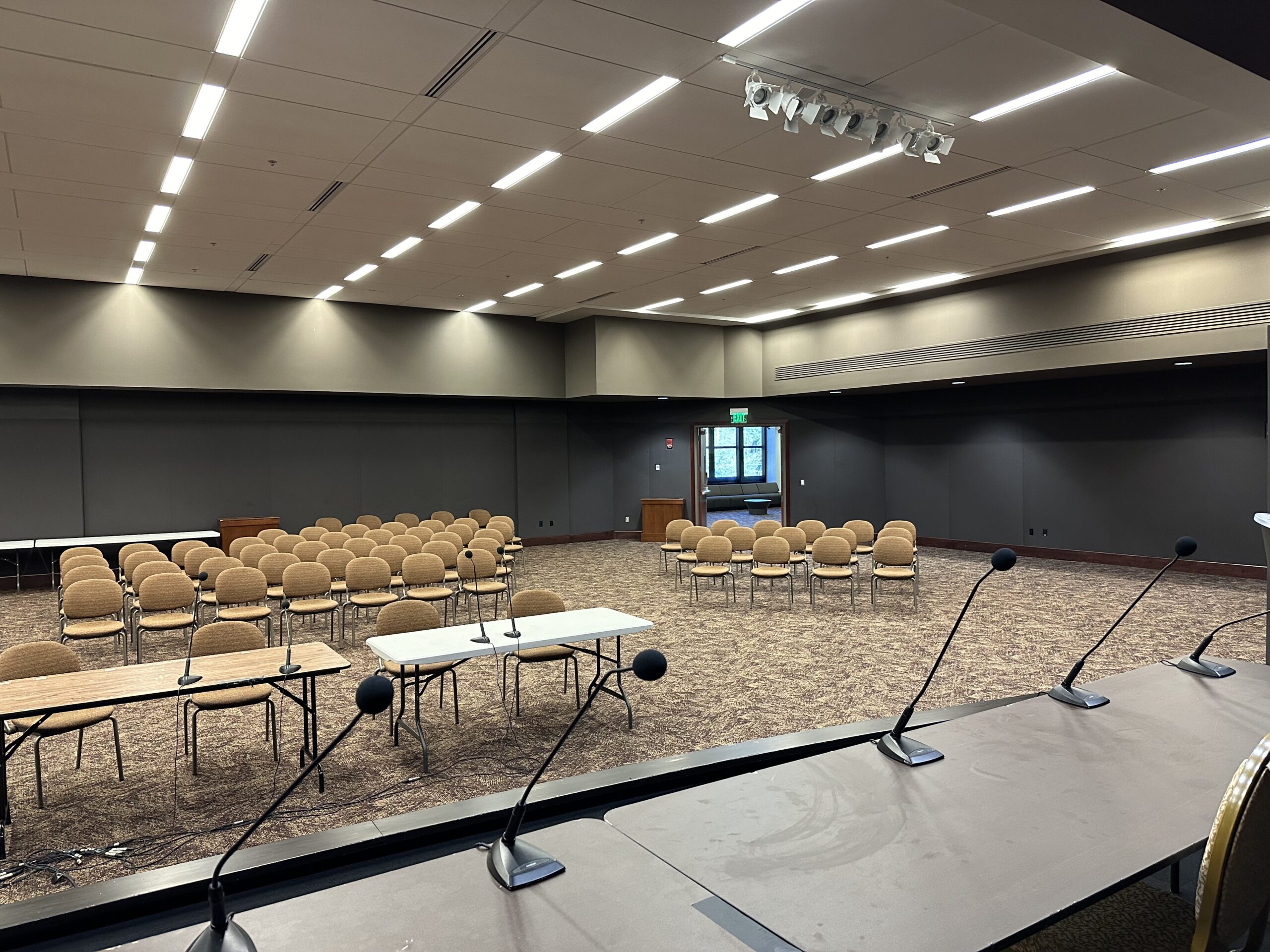 Room 208 viewed from the stage with microphones in foreground