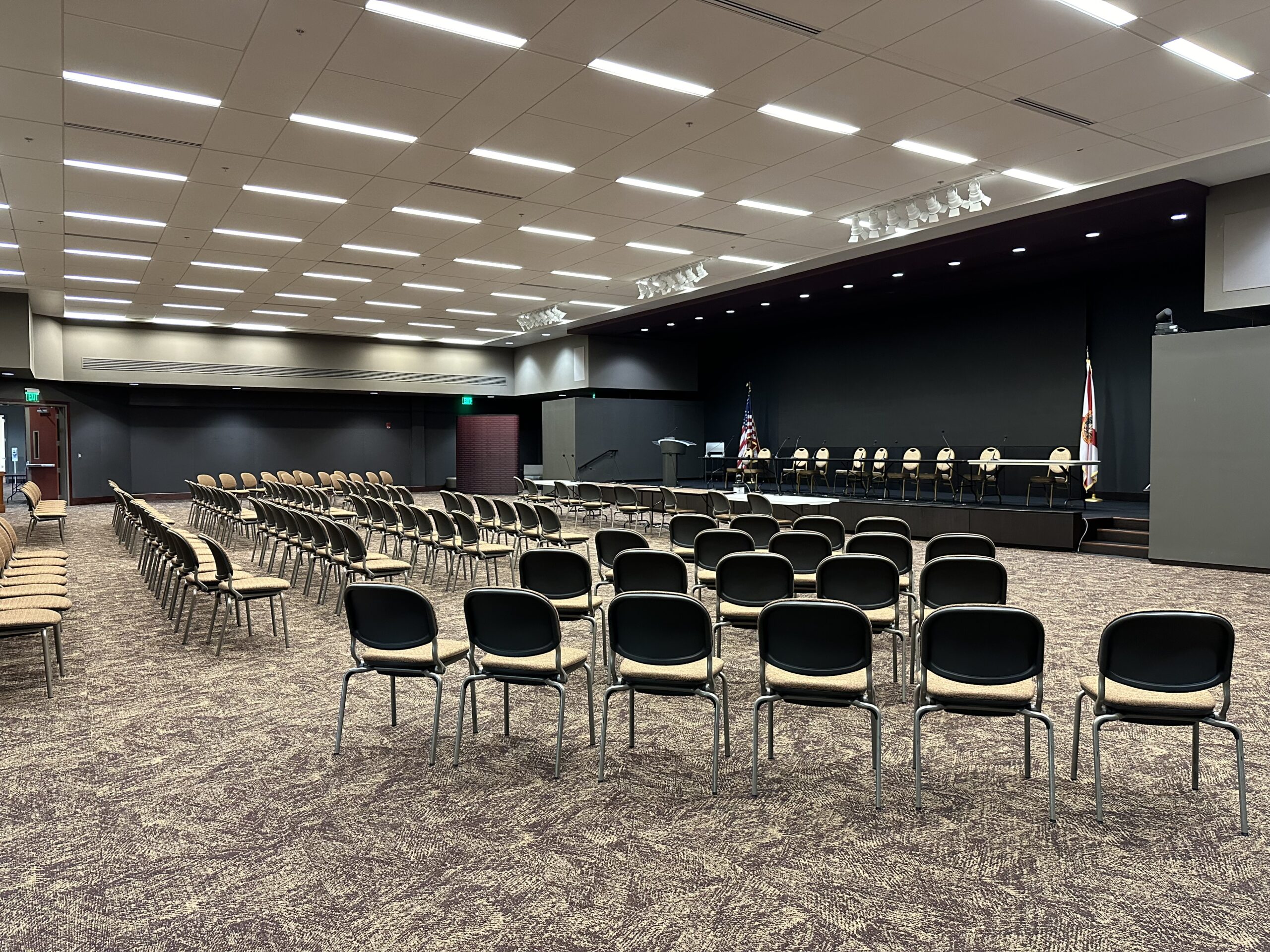 Wide view of Room 208 seating facing the stage
