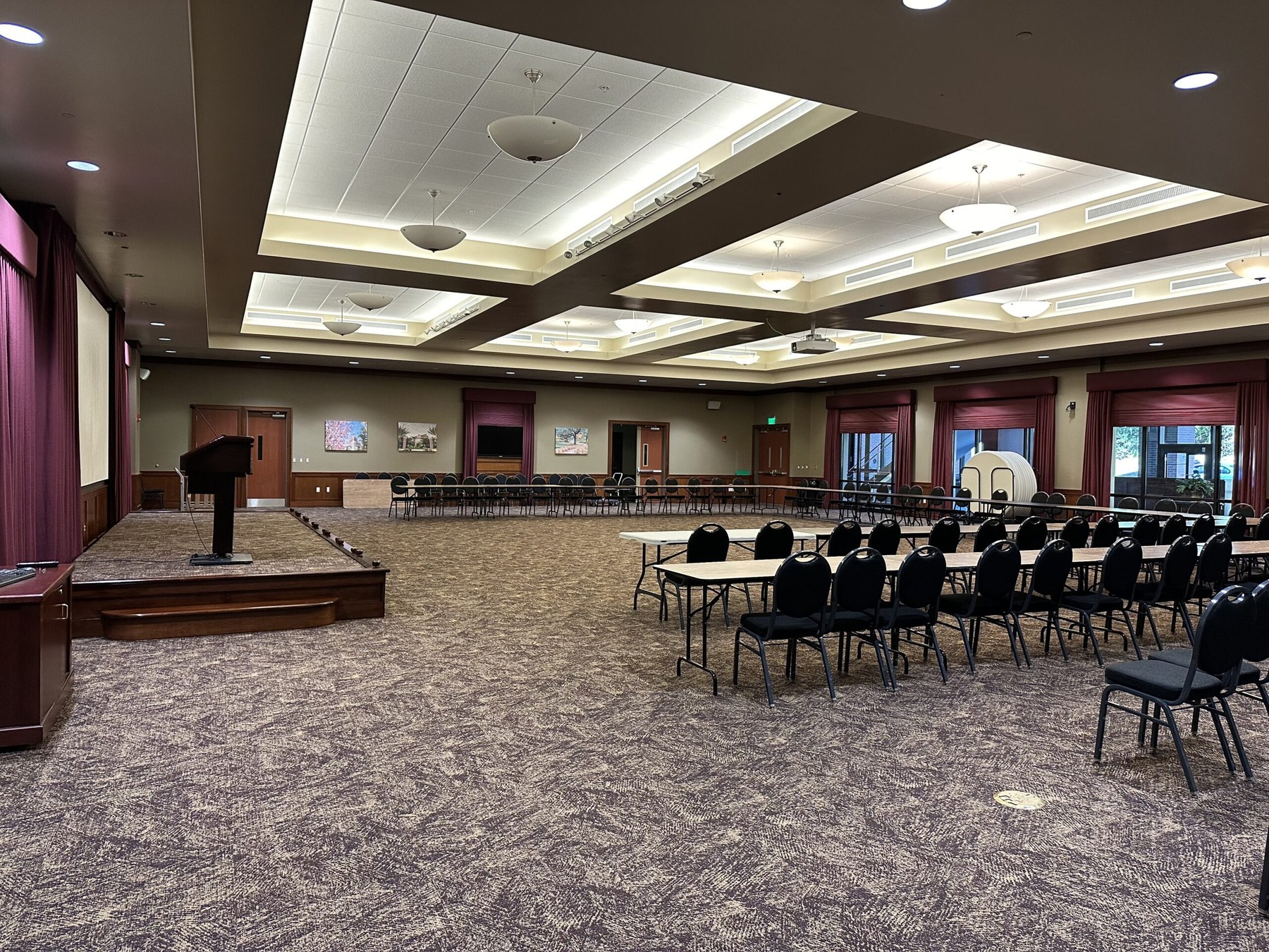 Wide view of Room 108 showing the stage and event seating